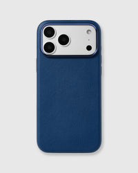 Navy fine-grain vegan leather iPhone case with a raised blue-tone metal camera frame by STICKYZOO