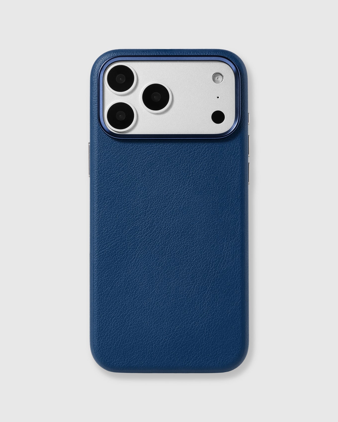 Navy fine-grain vegan leather iPhone case with a raised blue-tone metal camera frame by STICKYZOO