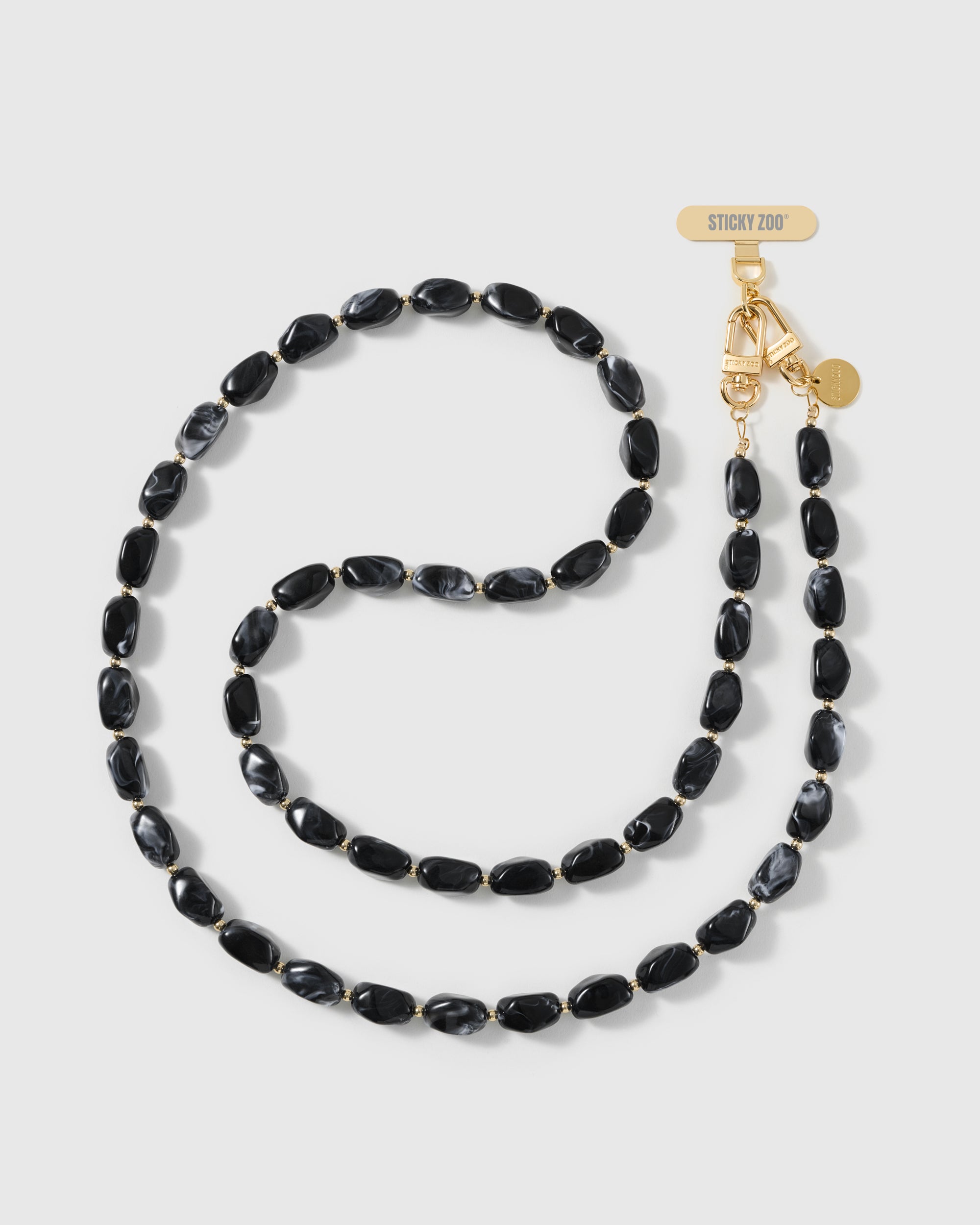 Full-length NOIR ORBIT cross-body phone strap in high-gloss black resin nugget beads with a smoky charcoal swirl, handmade by STICKYZOO