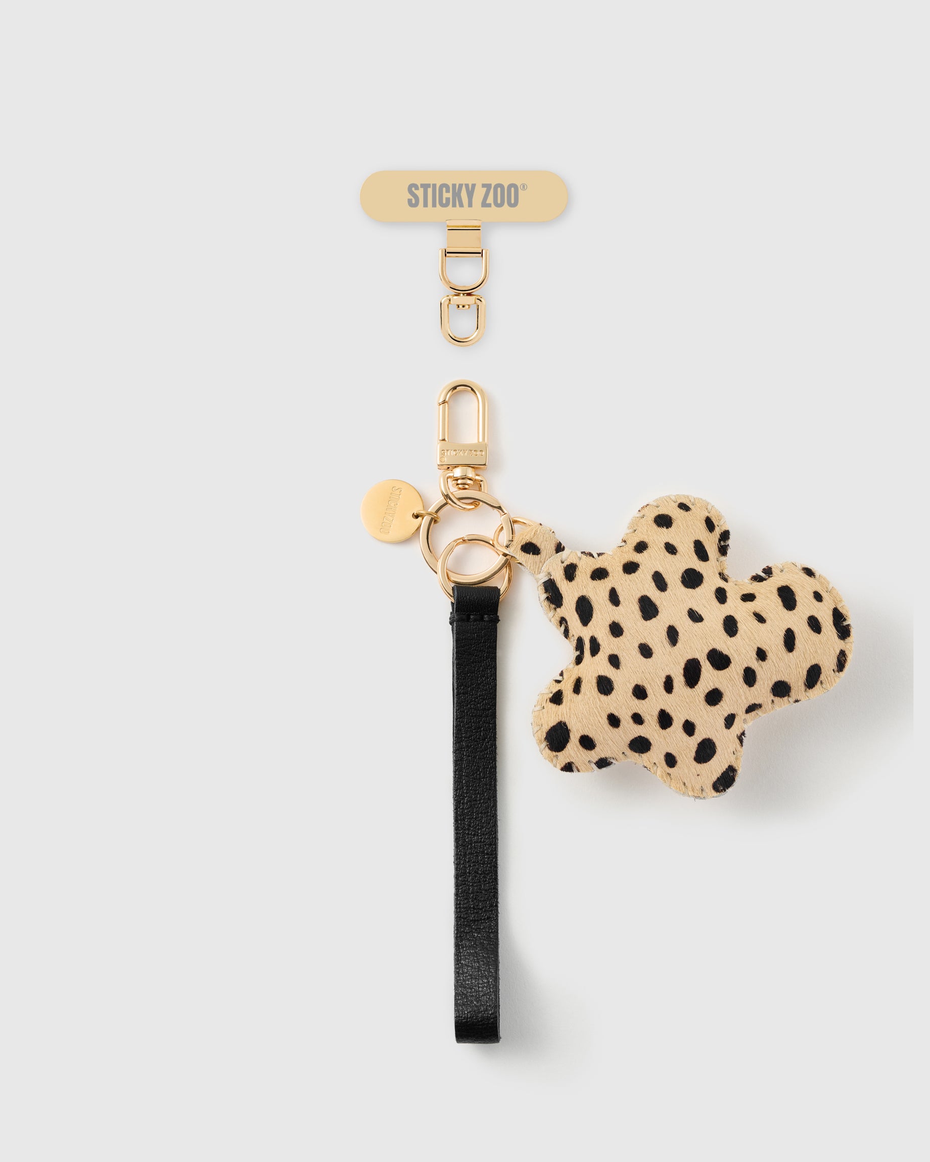 STICKYZOO cheetah flower leather phone strap — black Alran strap, cheetah calf-hair charm and gold hardware