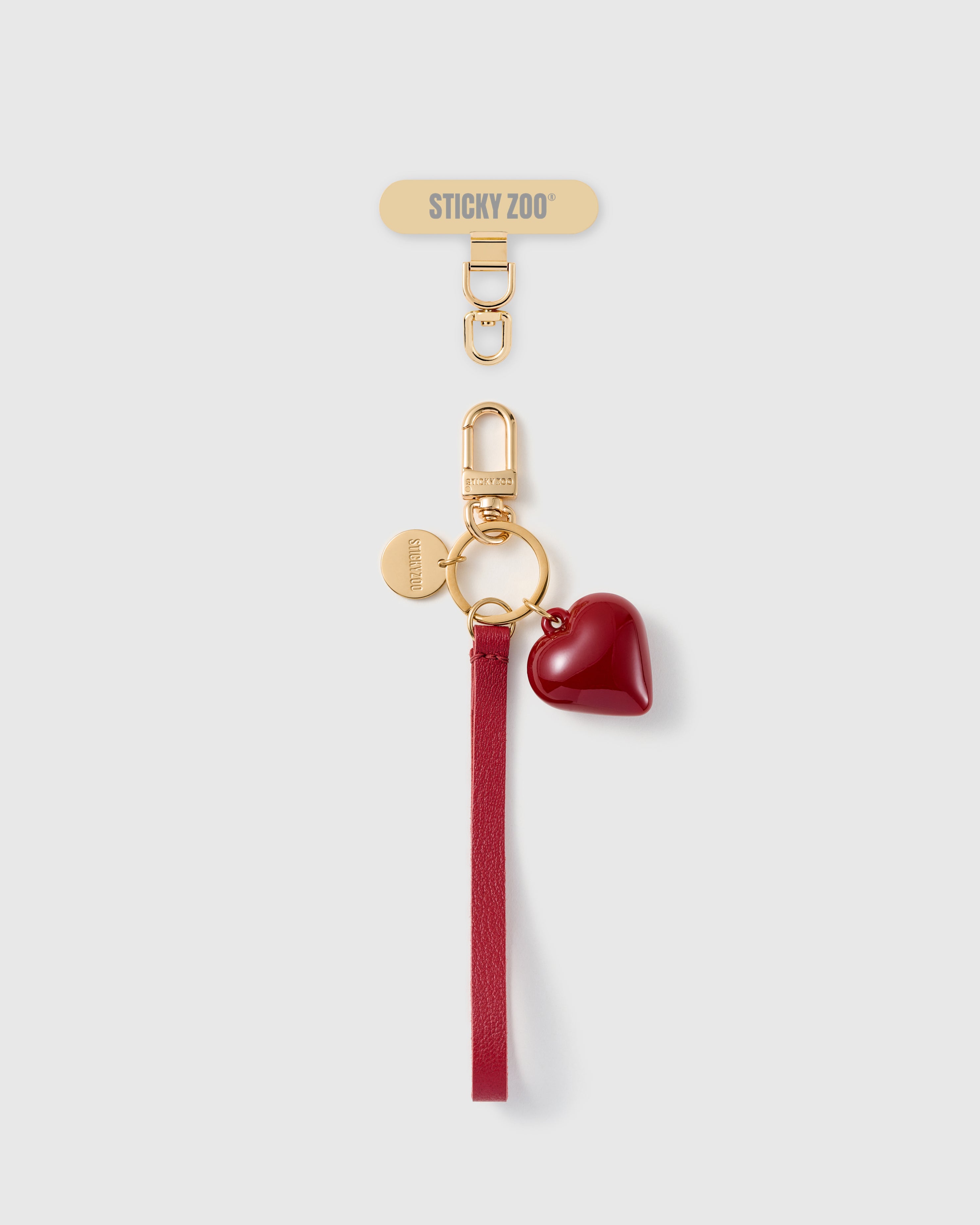 Handmade French Alran crimson red leather phone strap with glossy ruby puff heart charm and 18K gold STICKYZOO hardware