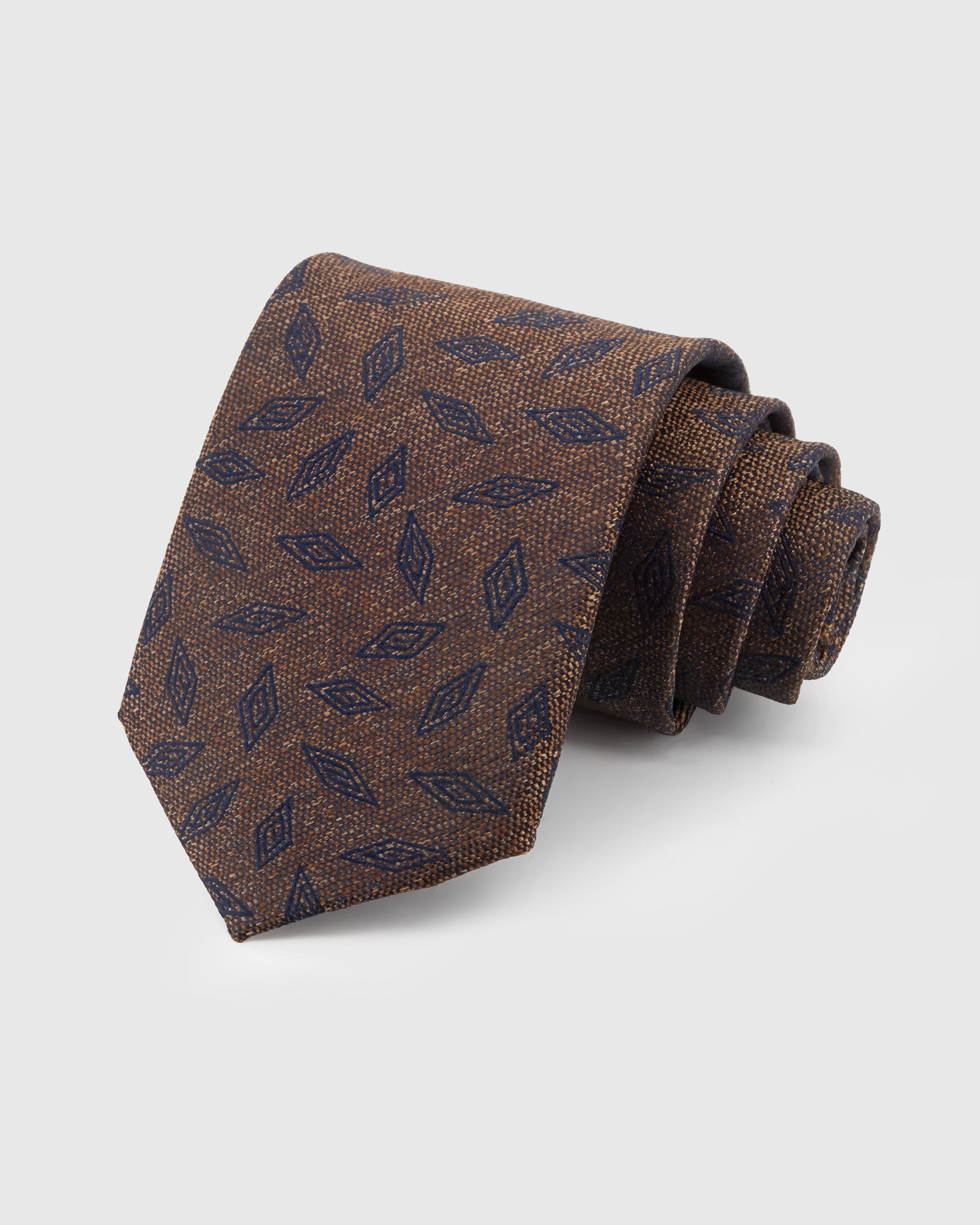 STICKYZOO Walnut Leaf Scatter Tie in hand-embroidered mulberry silk with navy leaf motifs on nubby ground, 45° bias-cut