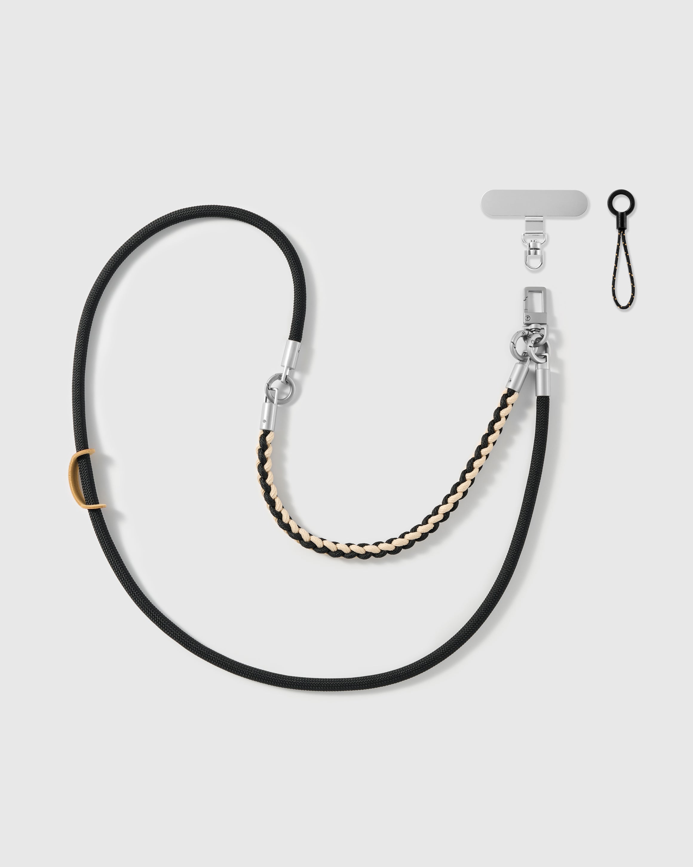 Cross-body phone strap shown with its universal phone-tab connector and safety tether