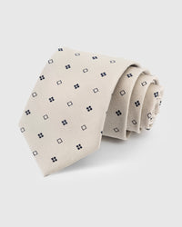 STICKYZOO Pearl Square Dot Tie in hand-embroidered mulberry silk with navy square dot motifs on off-white ground, 45° bias-cut