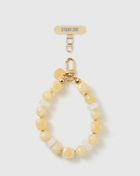 Handmade buttermilk beaded phone strap by STICKYZOO with 18K gold-plated engraved hardware