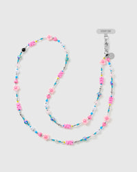 STICKYZOO cross-body phone strap laid in an S-curve, strung with pink flower beads, hearts, faux-pearl and turquoise beads, silver-tone tag and clasp.