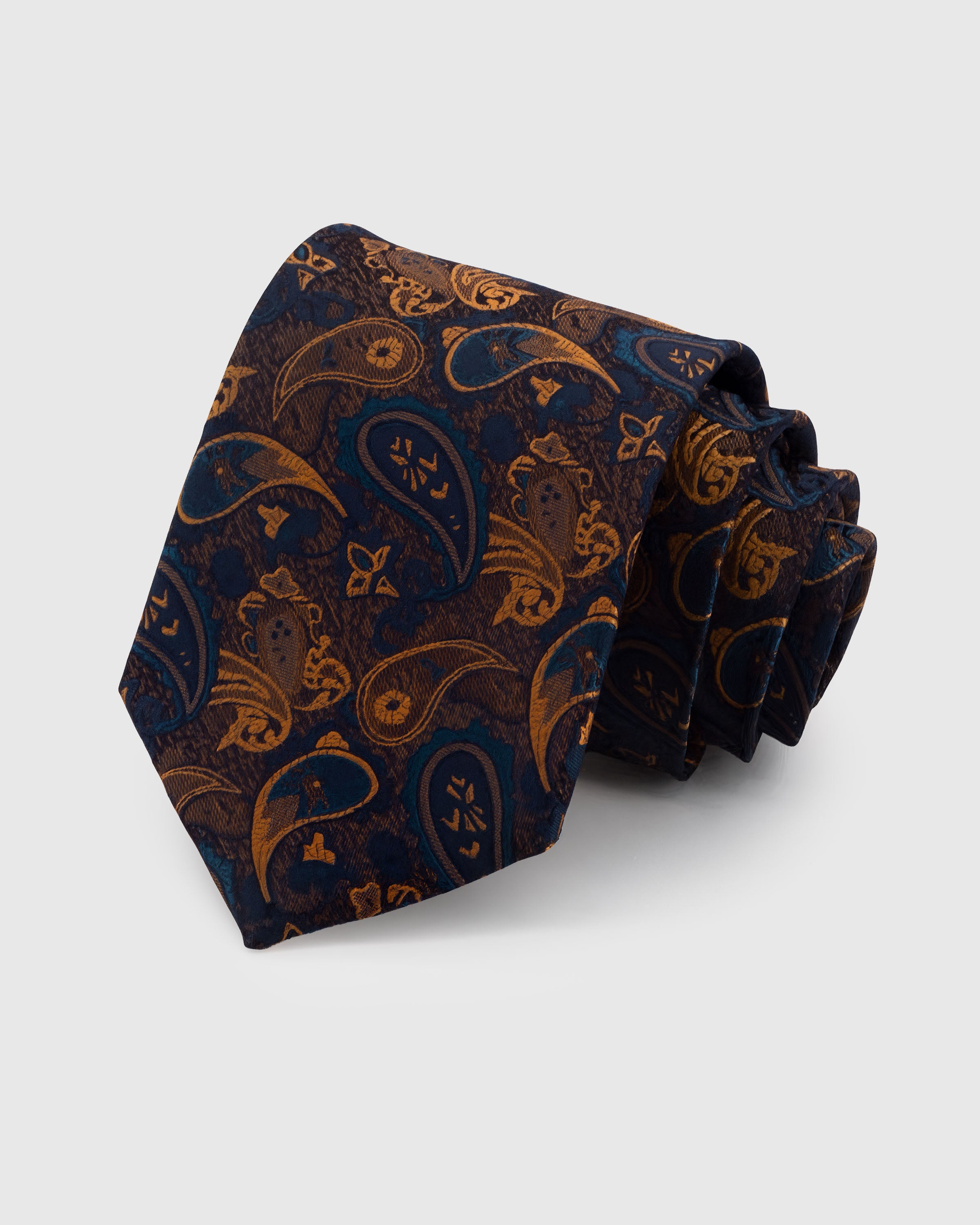 STICKYZOO INDIGO PAISLEY TIE — 100% mulberry silk with hand-embroidered golden-amber paisley teardrop motifs with floral detail on deep indigo navy ground