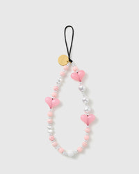 STICKYZOO Bubblegum Heart phone strap laid flat: candy-pink puff hearts, pearl-effect and silver heart beads, striped candy rounds, gold-tone disc.