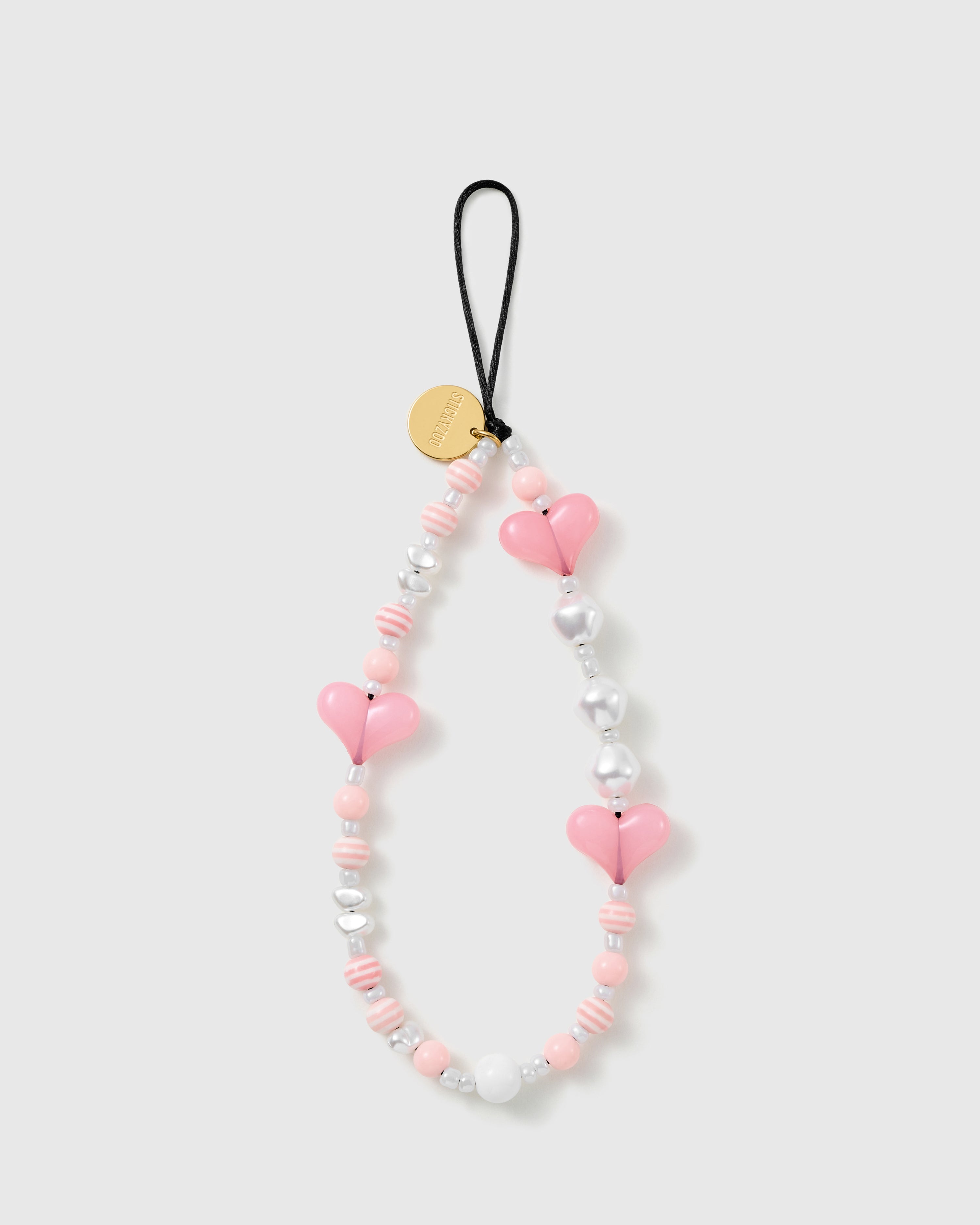 STICKYZOO Bubblegum Heart phone strap laid flat: candy-pink puff hearts, pearl-effect and silver heart beads, striped candy rounds, gold-tone disc.