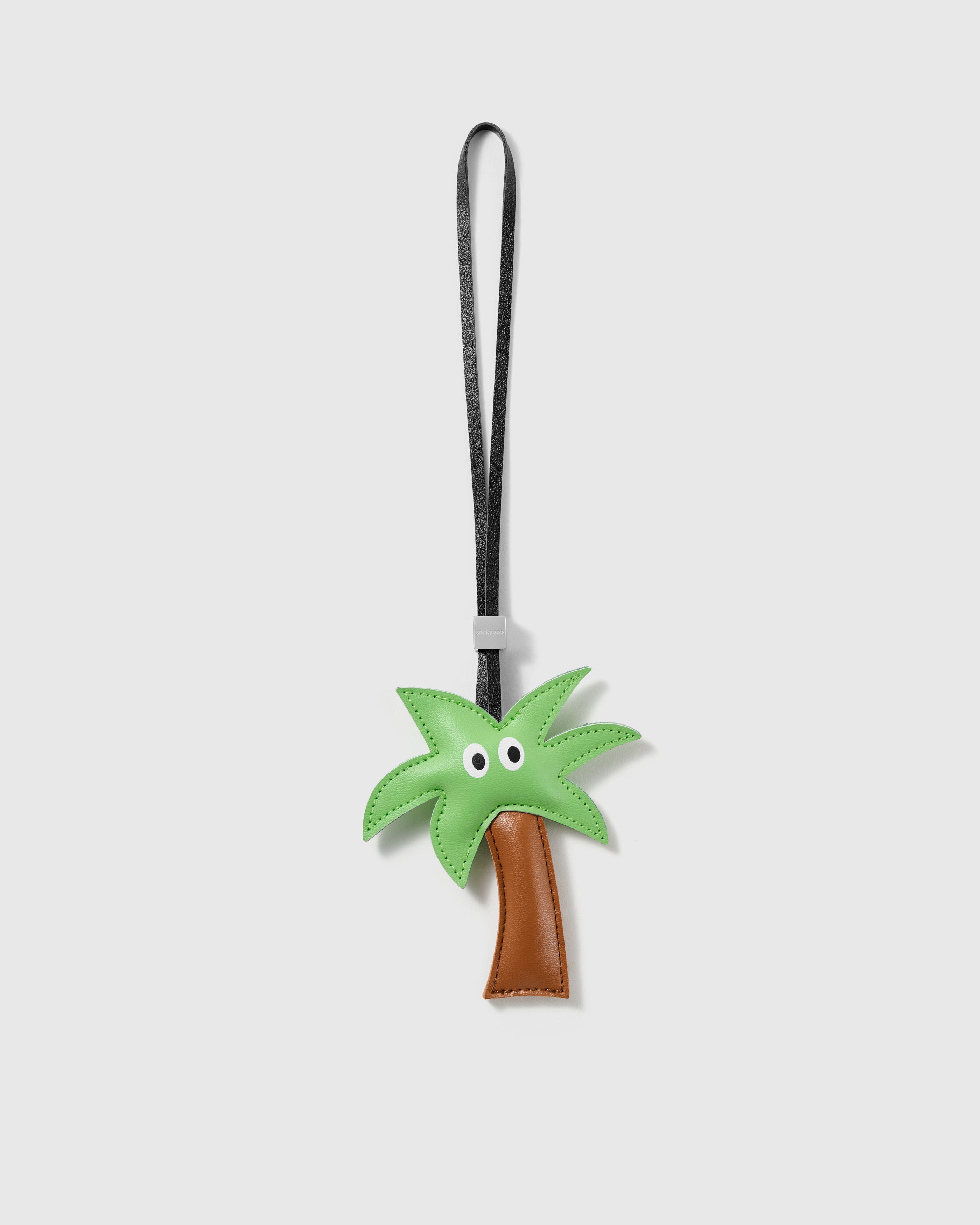 Handmade green French Alran leather palm tree bag charm with engraved 18K gold-plated hardware by STICKYZOO