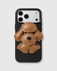 STICKYZOO Poodle Charm Case in brown — handmade French Alran leather poodle charm on black vegan leather phone case with raised bezels and MagSafe compatibility.