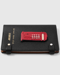 French Alran leather london phone booth charm detail showing hand-cut and hand-stitched layers with engraved gold-plated hardware