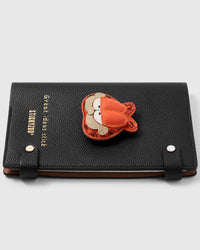 French Alran leather garfield charm detail showing hand-cut and hand-stitched layers with engraved gold-plated hardware