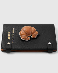 French Alran leather croissant with layered pastry detail on STICKYZOO notebook, hand-cut and stitched with multi-layer construction
