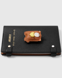 French Alran leather teddy bear holding a yellow heart on STICKYZOO notebook, hand-cut and stitched with multi-layer construction