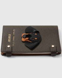 French Alran leather dachshund face charm detail showing hand-cut and hand-stitched leather layers on STICKYZOO notebook
