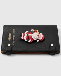 French Alran leather santa charm detail showing hand-cut and hand-stitched layers with engraved gold-plated hardware