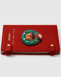 French Alran leather holiday beaver charm detail showing hand-cut and hand-stitched leather layers on STICKYZOO notebook