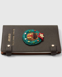French Alran leather beaver in holiday wreath holding a gift on STICKYZOO notebook, hand-cut and stitched with multi-layer construction