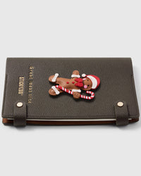 French Alran leather gingerbread man charm detail showing hand-cut and hand-stitched leather layers on STICKYZOO notebook