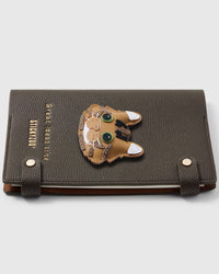 French Alran leather tabby cat face with green eyes and whiskers on STICKYZOO notebook, hand-cut and stitched with multi-layer construction