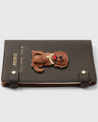 French Alran leather golden retriever charm detail showing hand-cut and hand-stitched leather layers on STICKYZOO notebook