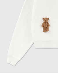 Detail of plush bear and ribbed hem on white 450gsm cotton fleece