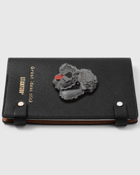 Poodle face charm detail showing hand-layered grey leather curls and red tongue on STICKYZOO A5 notebook