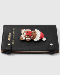 French Alran leather christmas gingerbread charm detail showing hand-cut and hand-stitched layers with engraved gold-plated hardware