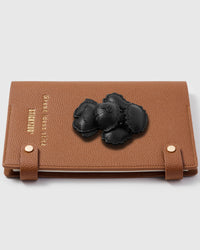 Black poodle teddy charm detail showing hand-layered scalloped leather curls and 3D depth on STICKYZOO A5 refillable notebook