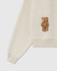 Detail of plush teddy bear and ribbed cuff on light gray 450gsm cotton fleece