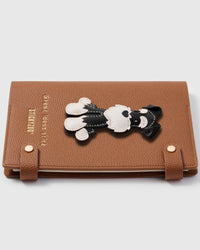 Schnauzer charm detail showing hand-cut black and white leather pieces with stitched beard and eyebrow detail on STICKYZOO notebook