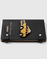 French Alran leather new york taxi charm detail showing hand-cut and hand-stitched layers with engraved gold-plated hardware