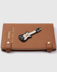 French Alran leather electric guitar charm detail showing hand-cut and hand-stitched leather layers on STICKYZOO notebook