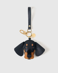 Dash Dachshund leather bag charm shown in both attachment options — handmade French Alran goatskin, dual attachment for bags or keys. STICKYZOO Amsterdam design.