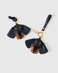 Handmade Dachshund leather bag charm with 18K gold-plated keychain clip and engraved STICKYZOO gold tag — for keys, bags, and backpacks. French Alran goatskin.