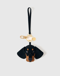 Dash Dachshund suede bag charm shown in both attachment options — handmade French Alran suede, dual attachment for bags or keys. STICKYZOO Amsterdam design.