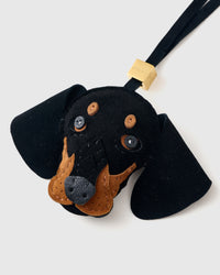 Handmade Dachshund suede bag charm clipped to a handbag — French Alran suede, 5-day artisan build. STICKYZOO suede edition.