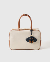 Handmade Dachshund leather bag charm clipped to a handbag — French Alran goatskin, 5-day artisan build. STICKYZOO leather edition.