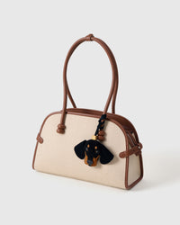 Handmade Dachshund suede bag charm on a handbag — built to last from French Alran suede, hand-layered, hand-stitched. STICKYZOO suede edition.