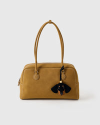 Handmade Dachshund suede bag charm shown on a handbag — hand-layered black and tan French Alran suede panels, soft-touch matte finish. STICKYZOO suede edition.