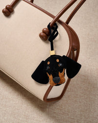 Handmade Dachshund suede bag charm with 18K gold-plated keychain clip and engraved STICKYZOO gold tag — for keys, bags, and backpacks. French Alran suede.
