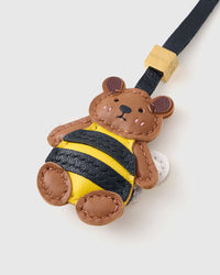 Both editions of the Honeybuzz Bear — leather strap loop for bags, or 18K gold-plated keychain clip.