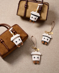 Wear it on a bag with the leather strap loop, or clip it to keys with the 18K gold-plated keychain clip. Two ways to carry one piece.