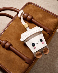 Wear it on a bag with the leather strap loop, or clip it to keys with the 18K gold-plated keychain clip. Two ways to carry one piece.