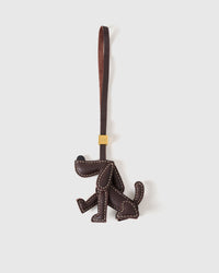 Handmade Basset Hound leather bag charm by STICKYZOO — minimalist silhouette in dark brown French Alran goatskin, hand-stitched over 3 days. Designed in Amsterdam.