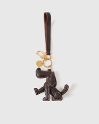 Handmade Basset Hound leather bag charm clipped to a handbag — French Alran goatskin, 3-day artisan build. STICKYZOO.