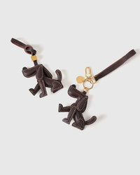 Basset Hound leather bag charm shown in both attachment options — handmade French Alran goatskin, dual attachment. STICKYZOO Amsterdam design.