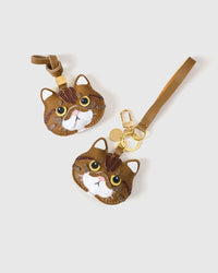 Both editions of the Exotic Shorthair side by side. French Alran leather from Tarn, France — founded 1903, Entreprise du Patrimoine Vivant.
