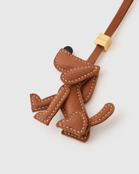 Handmade Basset Hound leather bag charm styled on a handbag — French Alran goatskin, 18K gold-plated hardware. STICKYZOO.